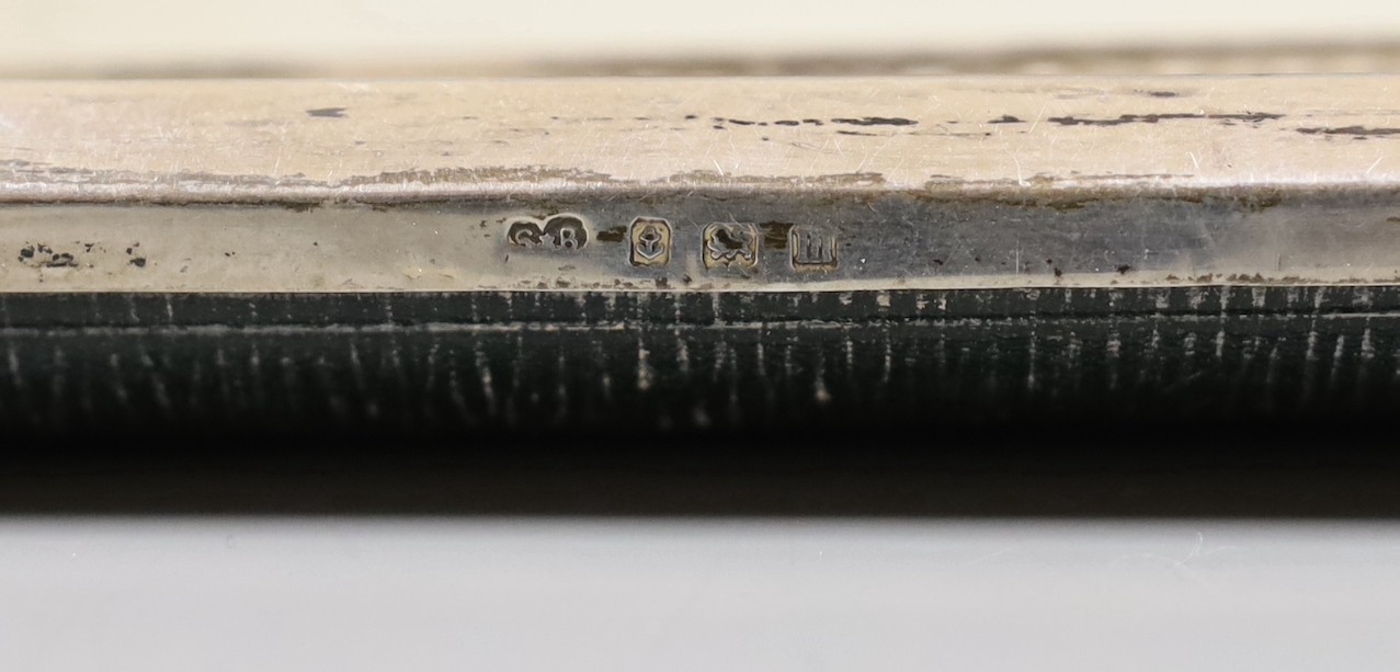 A George V planished silver mounted rectangular photograph frame, with canted corners, Synyer & Beddoes, Birmingham, 1911, 28.1cm, (lacks support arm).
